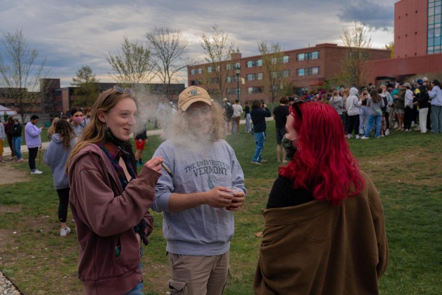 Three students stand smoking joints on the Redstone green April 20.