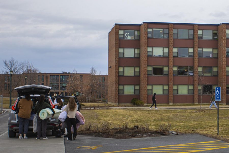 Students pack up their dorm belongings outside Harris-Millis Hall March 18.