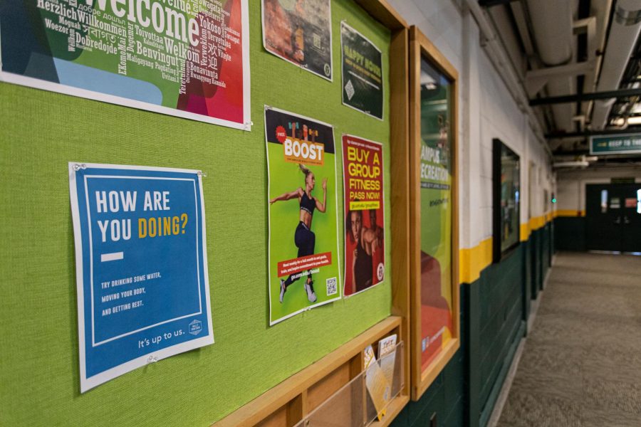 A UVM STRONG sign is pinned to a bulletin board outside the lower track in the Patrick Gym.