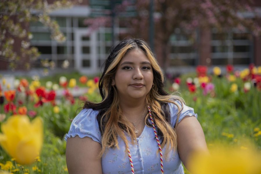 Senior Jaylyn Chalco sits amongst spring tulips May 9.
