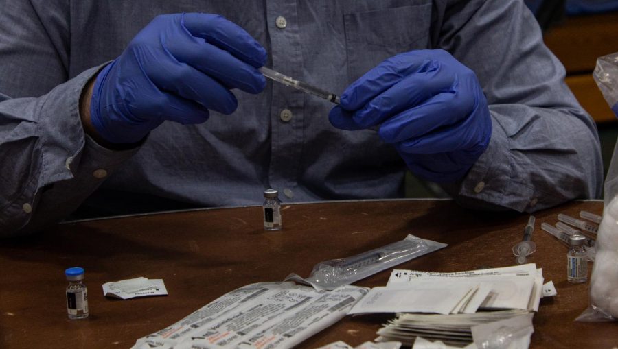 A worker caps a syringe that was recently filled with a dose of the Johnson and Johnson vaccine May 2.