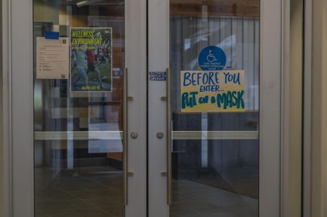 A sign reminds students to put their masks on before they enter Aug. 28.