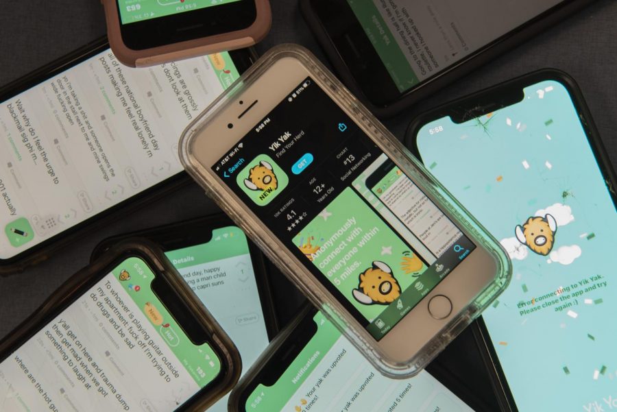 Eight phones sit on a table open to Yik Yak Oct. 3.