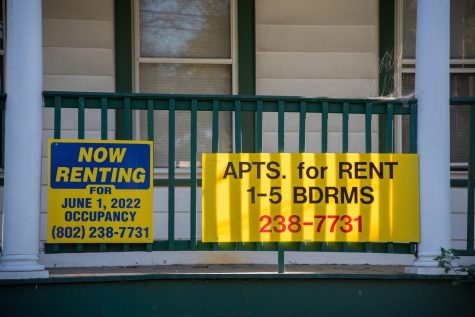 Signs advertise apartments for rent on College Street.