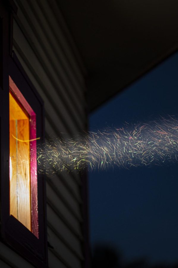 During a long exposure thousands of bugs can be seen flying in the light of the projector June 21.