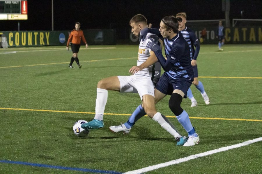 Members of UVM and Villanova University’s mens soccer teams fight for the ball during their game Nov. 18.