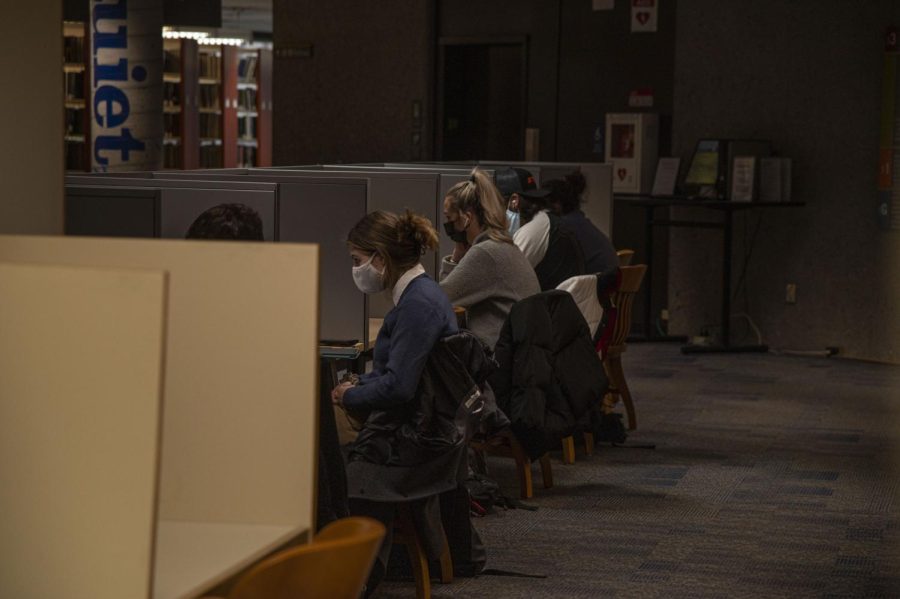 Students do work in individual cubicles on the second floor of the Howe Library.
