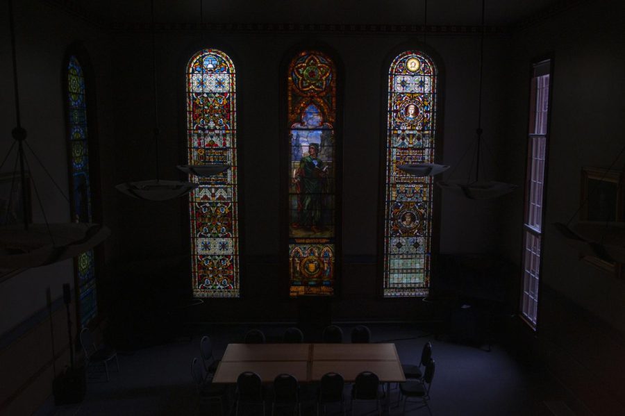 The Dewey Lounge in Old Mill is faintly lit with light pouring in through the stained glass windows Nov. 17.