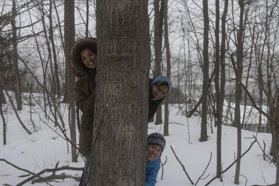  People of Color Outdoors’ leaders, senior Julia Bolton, senior Benny Berkenkotter and first-year Amenya Jean, pose behind a tree on Jan. 28.

