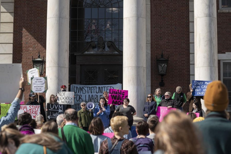  Chrysanthemum Harrell ‘22 speaks in front of the crowd March 16. She stands among members of Staff United holding signs expressing activism.
