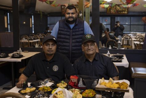 Masala Elaichi, an Indian Restaurant located at 207 Colchester Ave, provides authentic and affordable Indian cuisine to its customers. Owner Varinder Matri stands with his father-in-law, Suraj Mattri, and his brother.