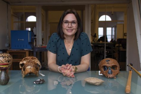 Assistant Archeology Professor Marieka Brouwer Burg in her office with replica Belizean pots and replica skulls March 24.