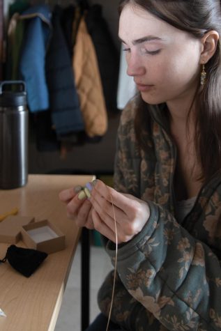 Julia Lenz makes a pair of earrings in her dorm March.