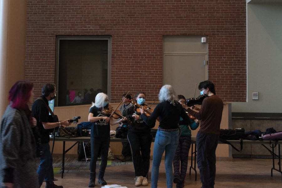 A group of musicians plays music outside of CatPause in the Davis Center atrium. 