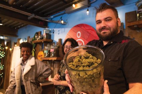 Baker shows off a jar of cannabis April 15.