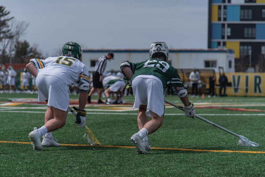 UVM #15 Charlie Egan and Binghamton #29 Teddy McLoughlin wait for the face-off April 23. 