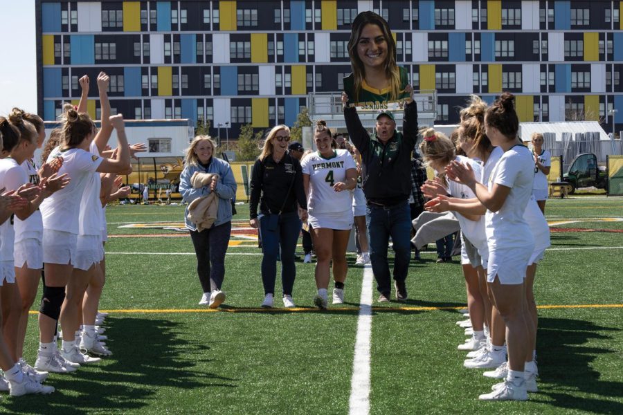  UVM women’s lacrosse players cheer on fifth-year defender Jessica English during the teams senior day ceremony April 30. UVM lost against Binghamton University 11-10 but will head to the semifinal round of the America East tournament May 5.
