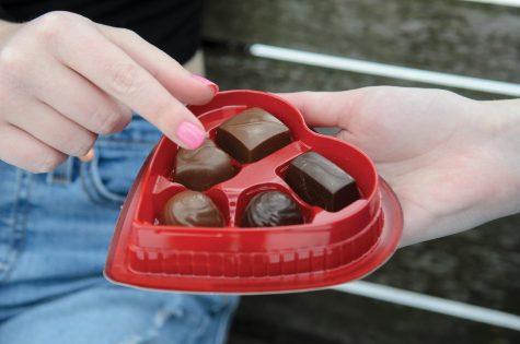 Photo Illustration: Students celebrating Valentine’s Day with a box of chocolate . College students’ plans for Valentine’s Day range from a crepe dinner over FaceTime to an Applebee’s outing. 