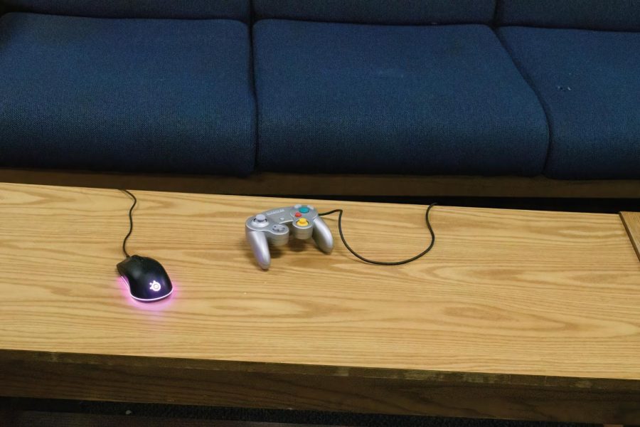 Photo Illustration: A video game controller and computer mouse on a common room table in Jeanne Mance Hall Feb. 9.