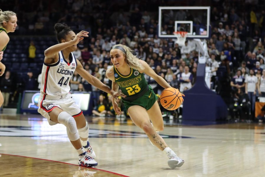 Senior guard Emma Utterback makes a move on a UCONN defender during the women’s game March 18.