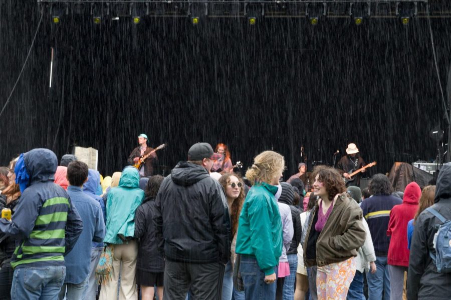 Students listen to music in the rain. 
