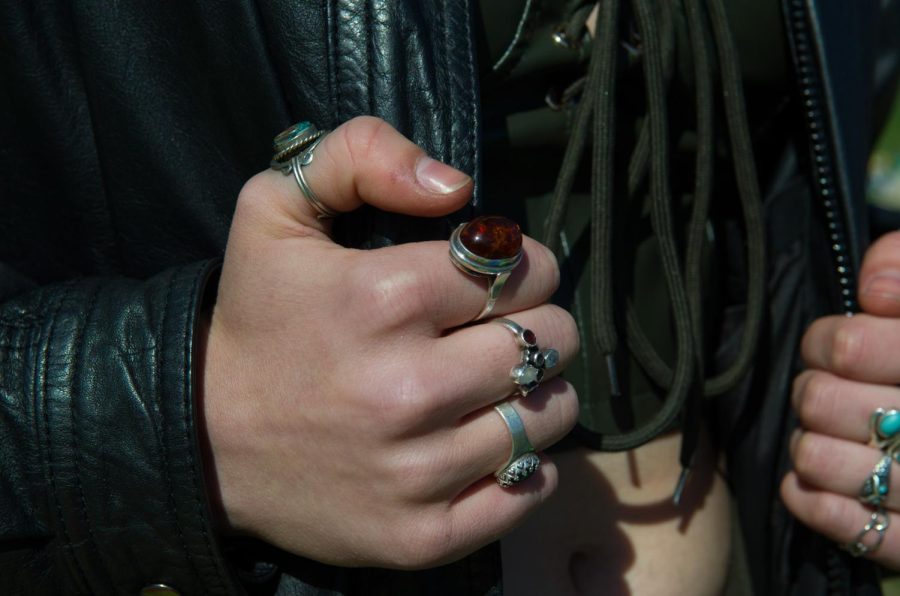 Luikart’s rings are shown as she clutches her leather jacket.