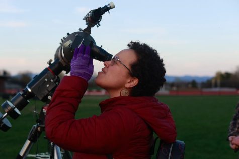 A student looks through a telescope at UVM Space Clubs stargazing night on the Livak track April 20.