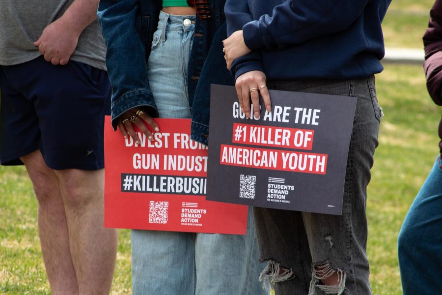 Students rally together calling for UVM to divest from the gun industry on the University green April 12.