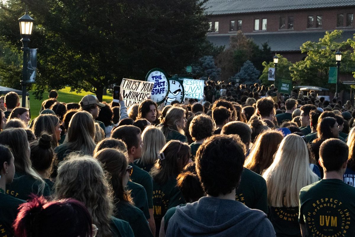 First-year students begin their walk to the Twilight Induction ceremony after Convocation, passing by Staff United protesters August 27. 