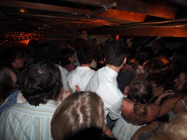 Students fill a crowded basement for a local concert.