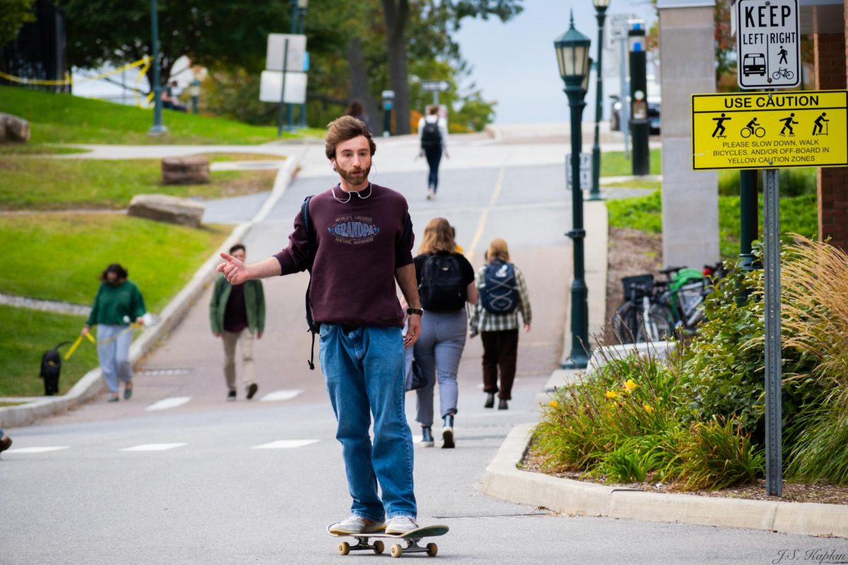 A UVM student casually skating in front of the Grossman School of Business Oct. 10.