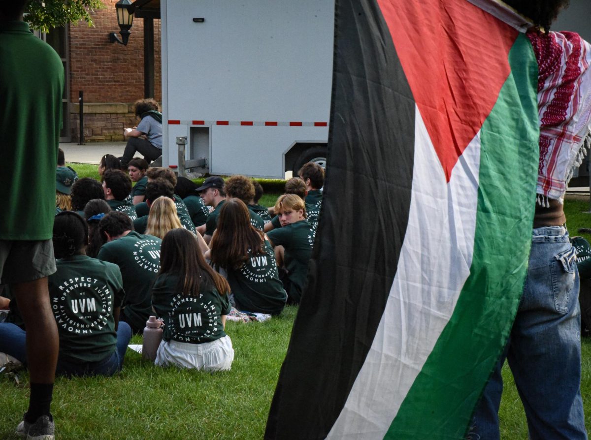 Protester stands with a Palestinian flag at convocation Aug. 25.
