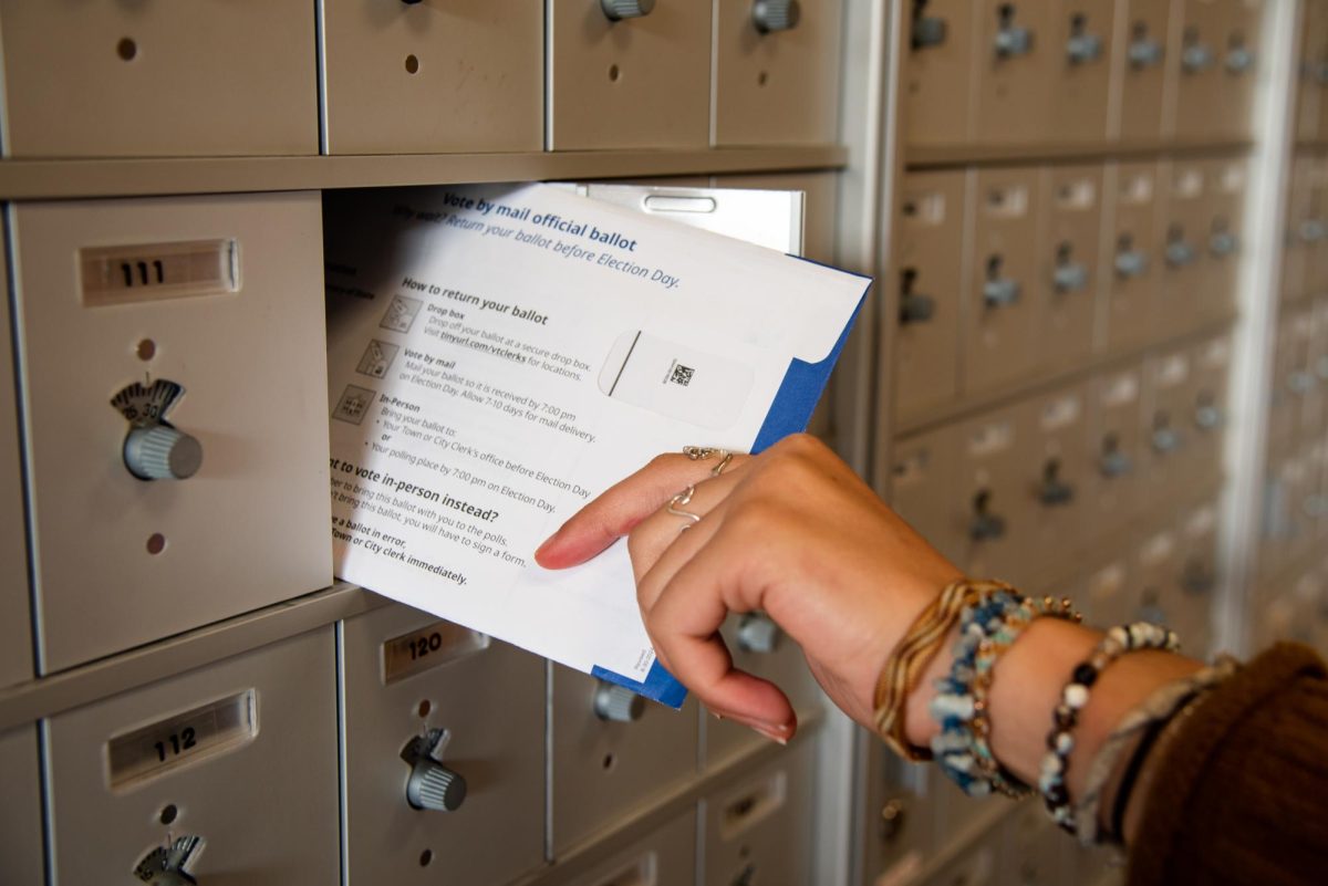 Photo Illustration: Student receiving their absentee ballot. 