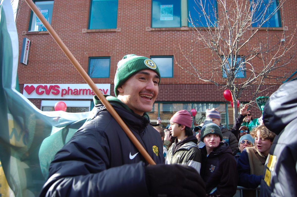 A member of the UVM men’s soccer team parades down Church Street  Jan. 26.
