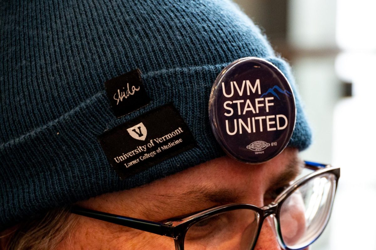 A member of Staff United wears a pin on their hat.