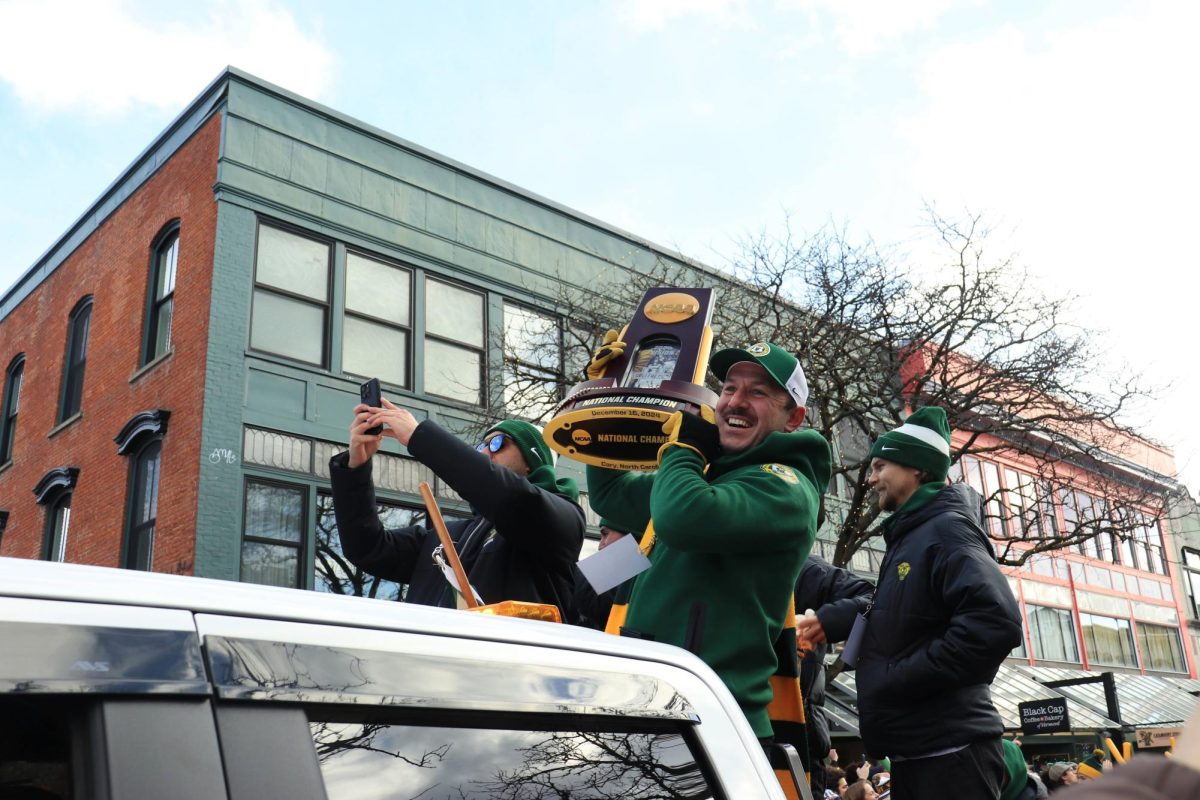 Members of the team hold up the trophy Jan. 26.