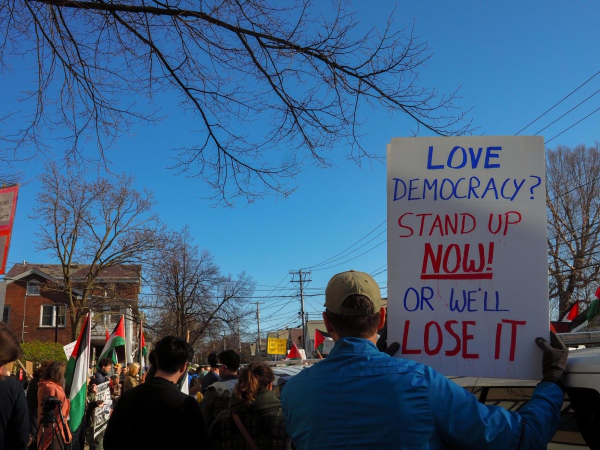 A protestor holds a sign. 