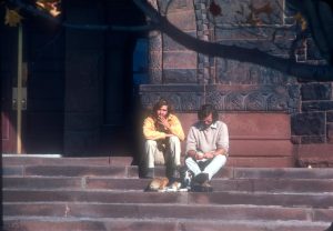 Two guys sit outside of Billings Library smoking a cigarette 1974. 
