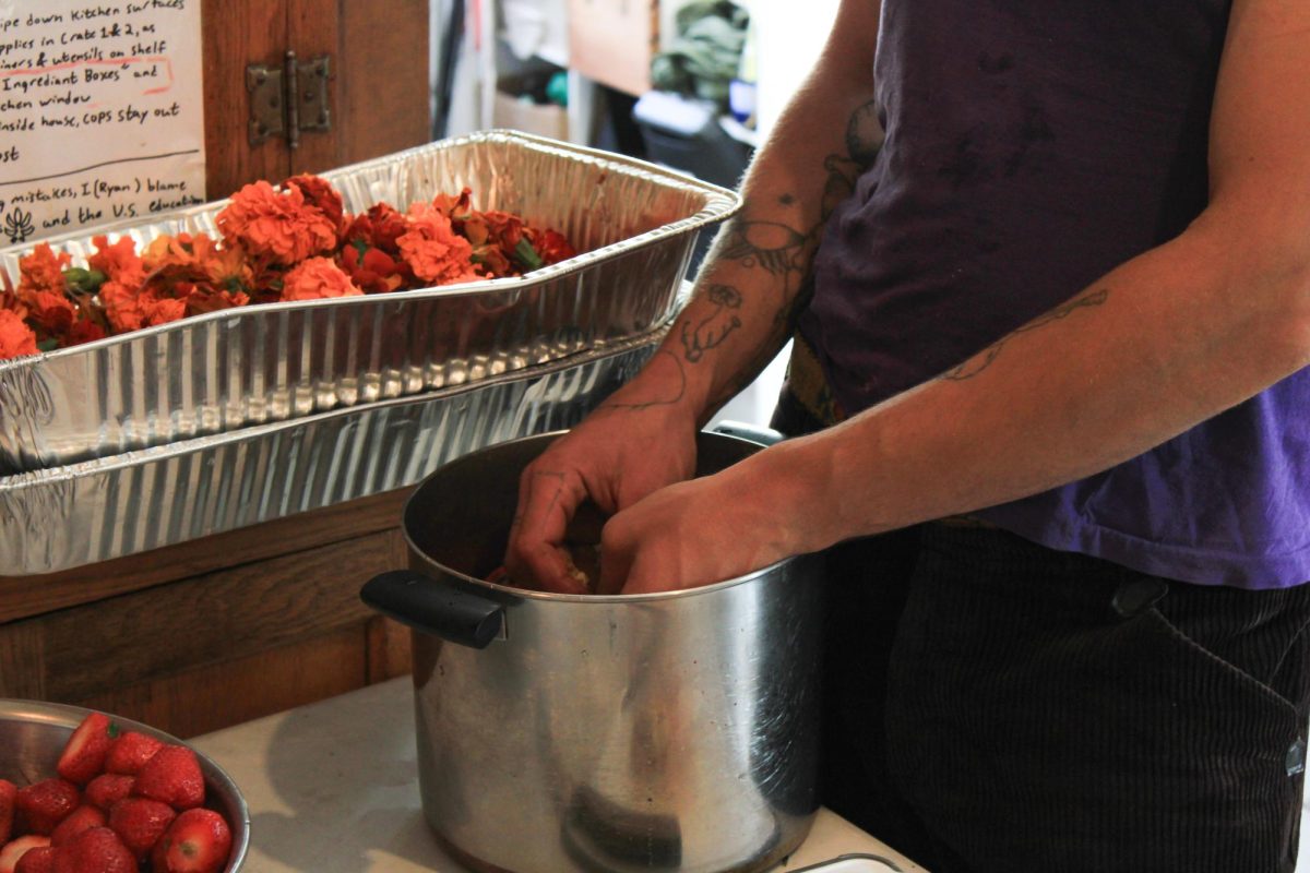 Person cooking at Food Not Cops, Sept. 26.